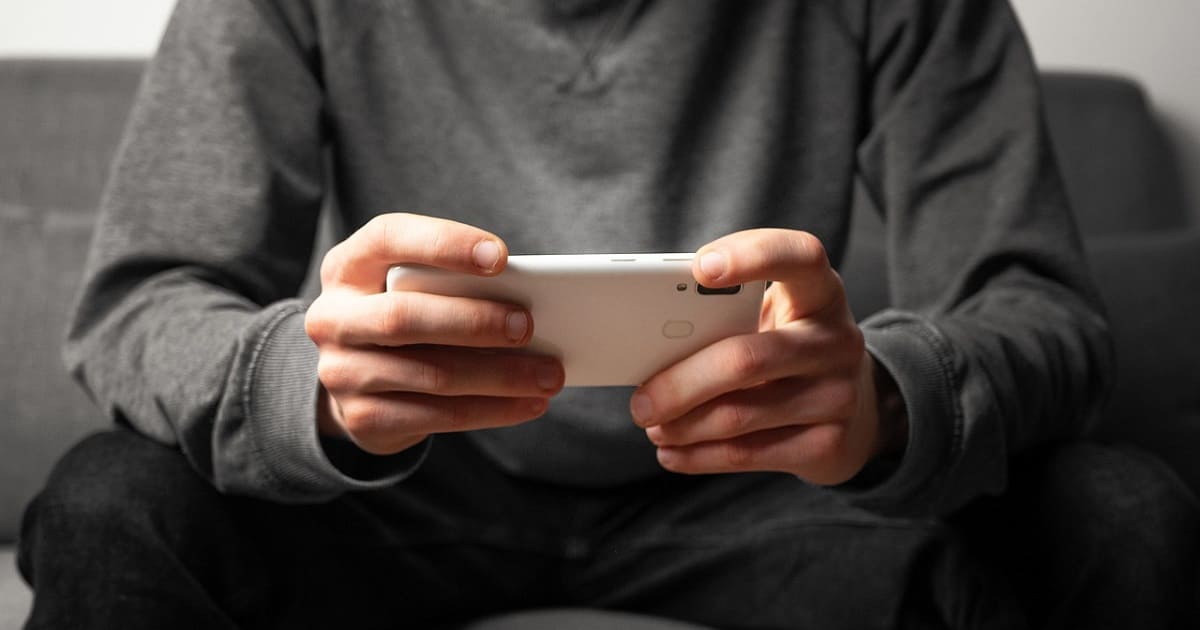 man playing on mobile